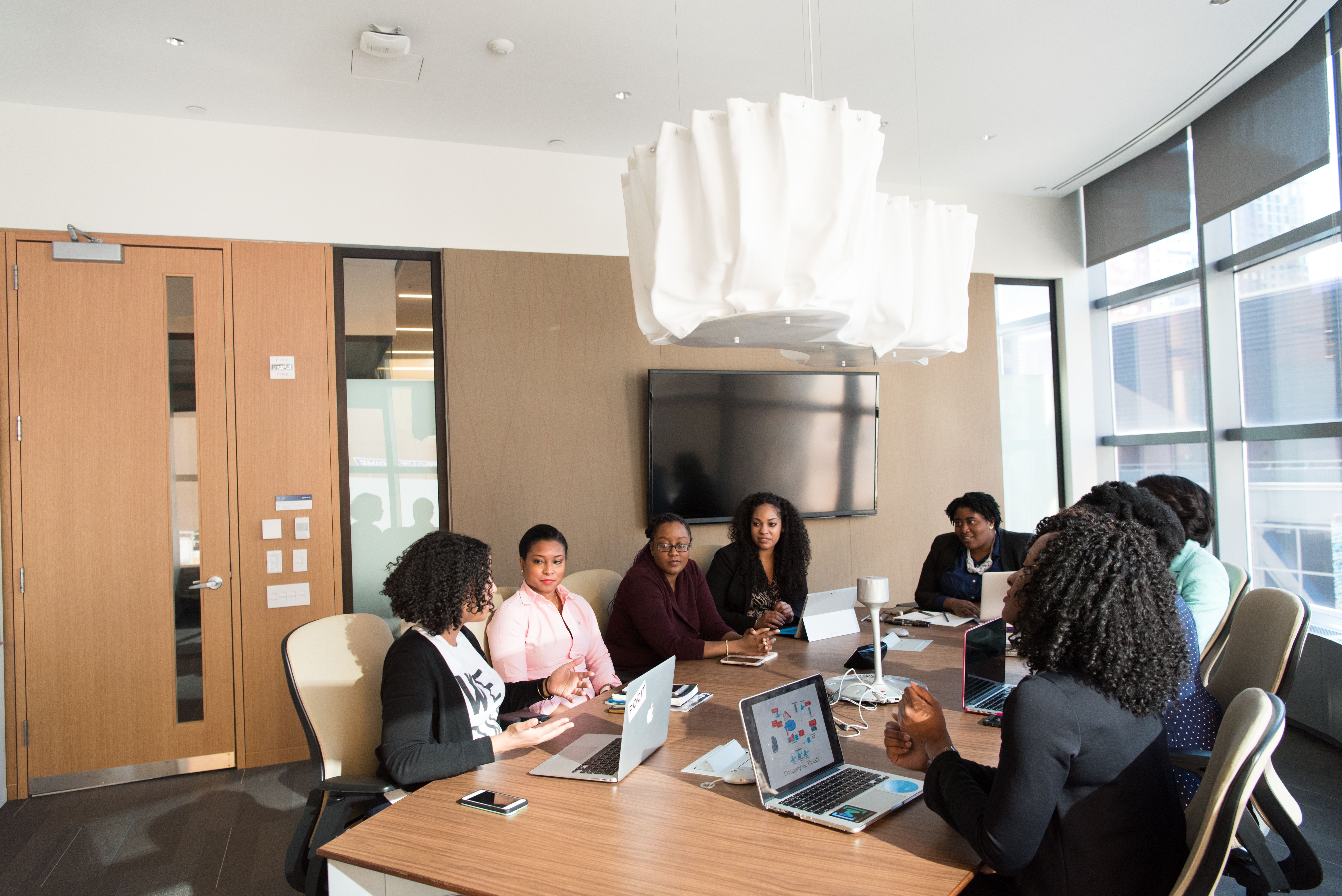 Team collaborating in a modern office meeting room at night