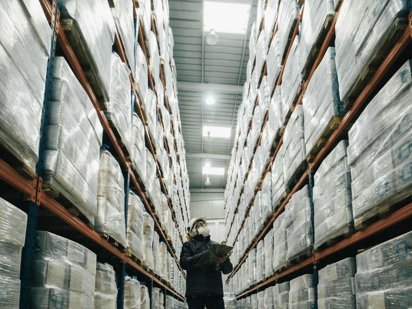 Warehouse worker checking inventory in a distribution centre