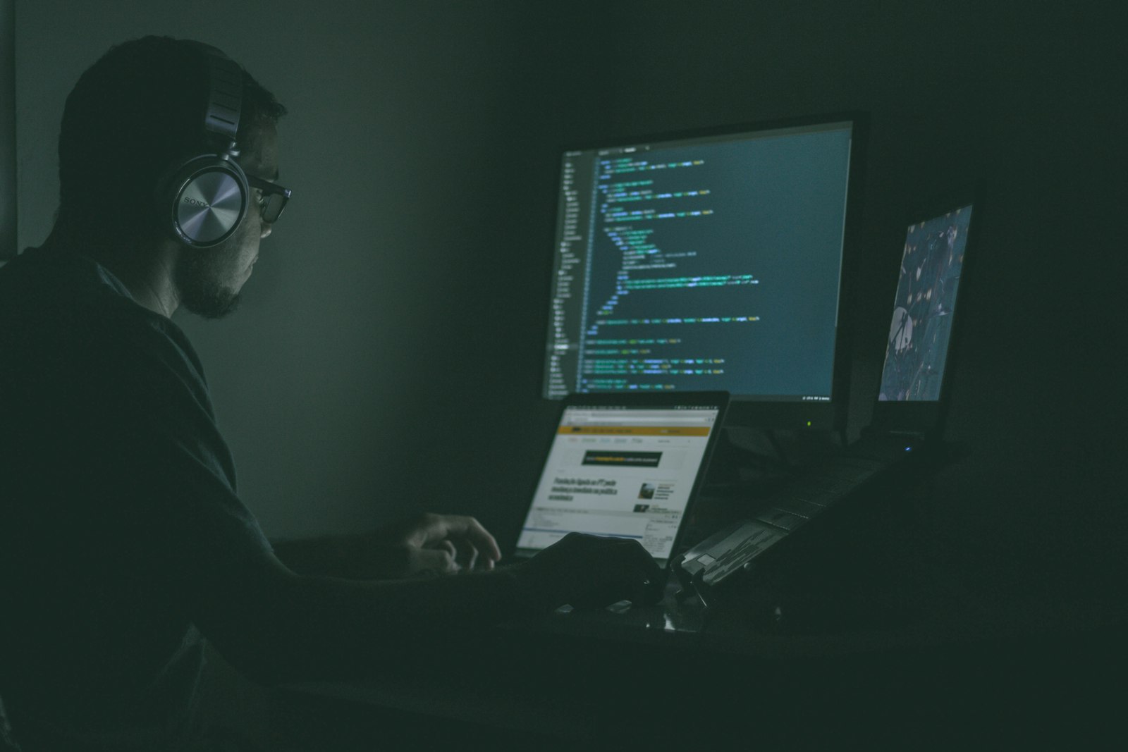 Security analyst monitoring systems at a dark workstation
